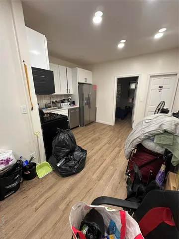 a bedroom with furniture and a flat screen tv