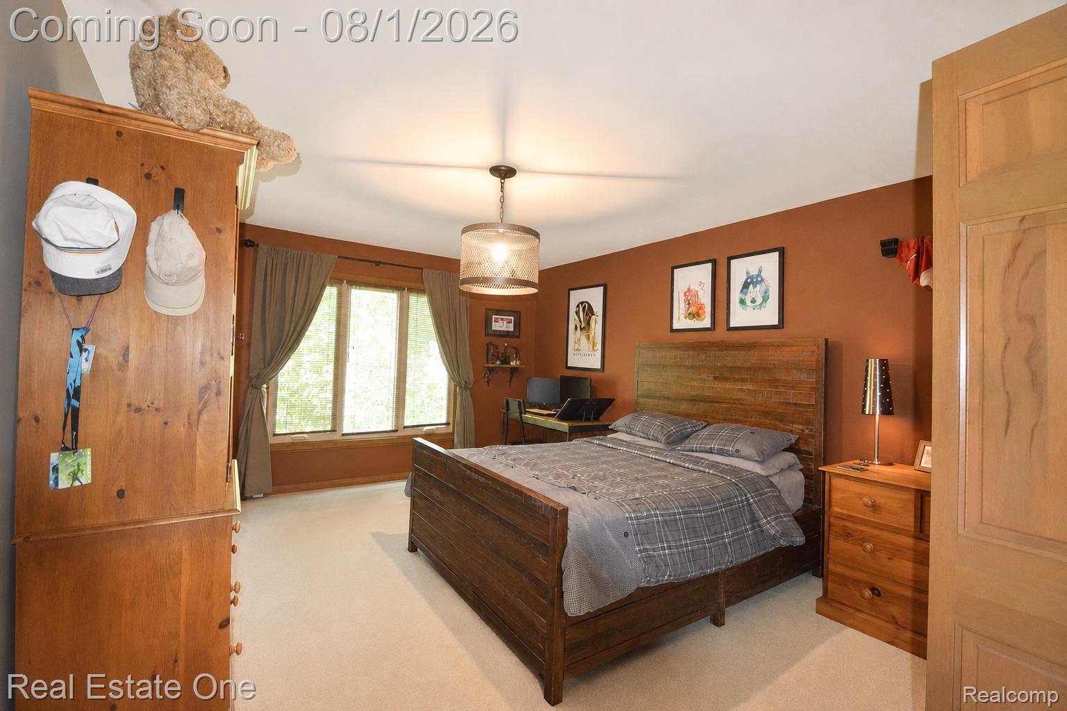 1370 Springwood Lane Rochester, MI 48309 - Photo 20 of 37 Carpeted room featuring a wide window with a deep sill, a light fixture, and a built-in wood-finish cabinet