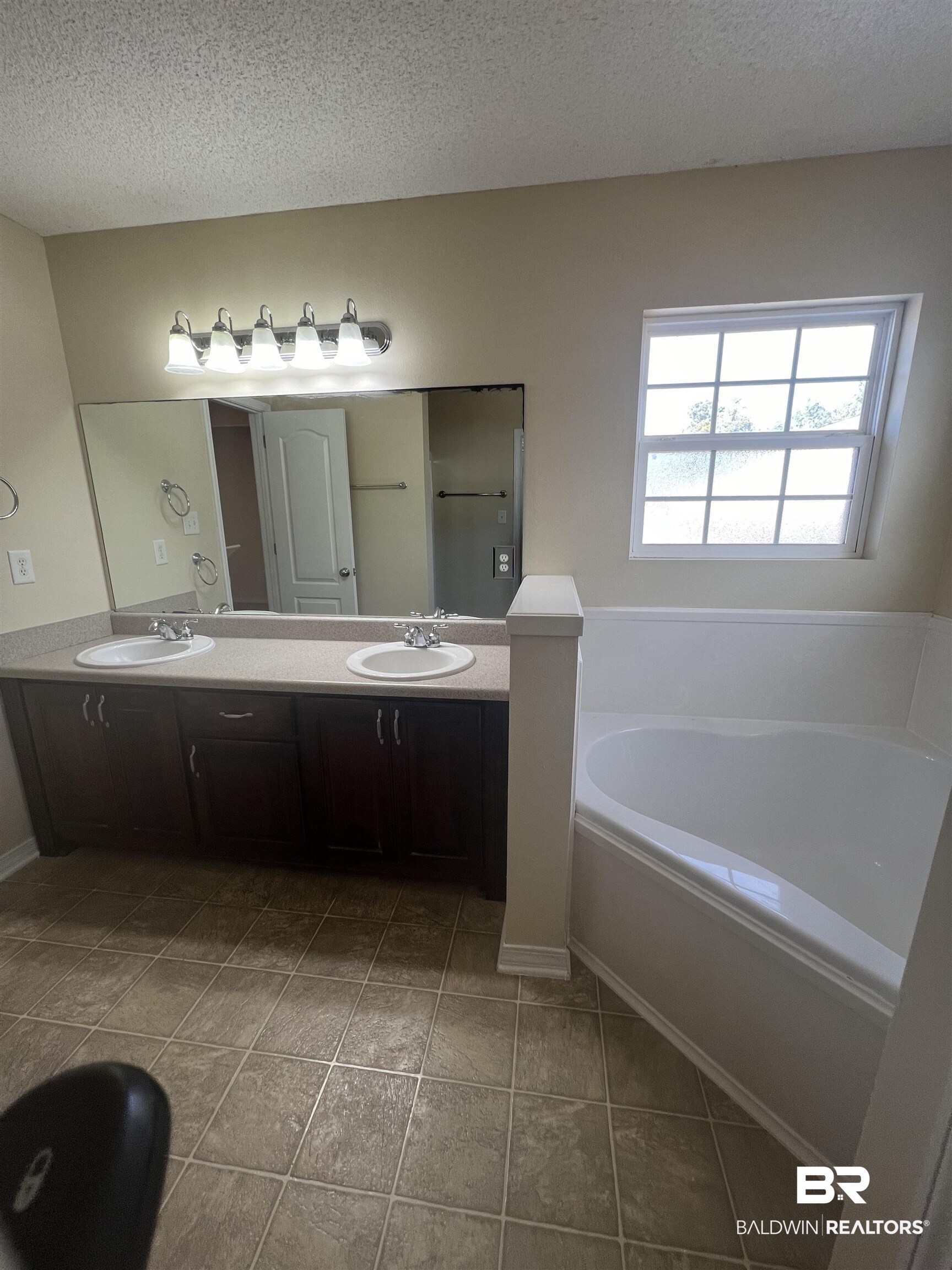 17793 Fancy Boulevard Foley, AL 36535 - Photo 16 of 34 Bathroom featuring vanity, a tub, tile patterned floors, and a textured ceiling
