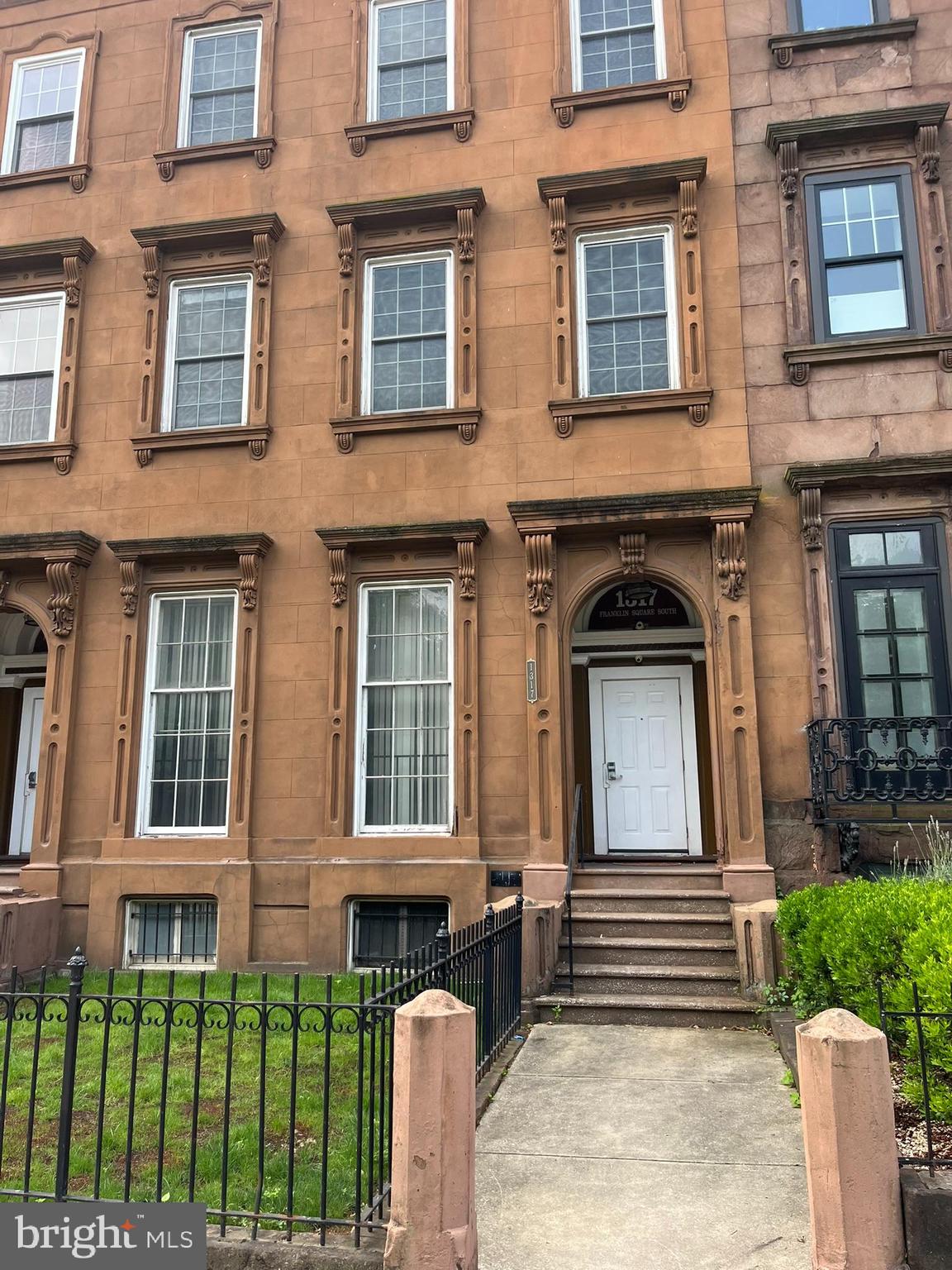 1317 West Fayette Street, Unit 3B Baltimore, MD 21223 - Photo 1 of 32 a front view of a house with a yard