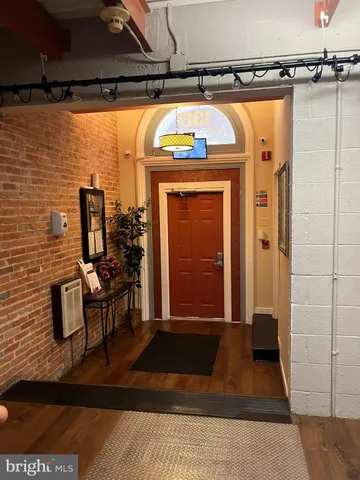 a view of a entryway door with couch