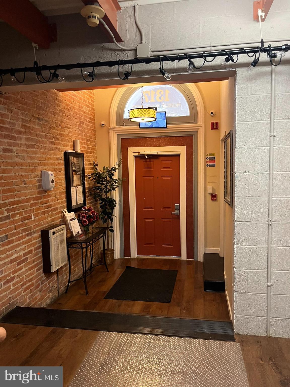 1317 West Fayette Street, Unit 3B Baltimore, MD 21223 - Photo 3 of 32 a view of a entryway door with couch