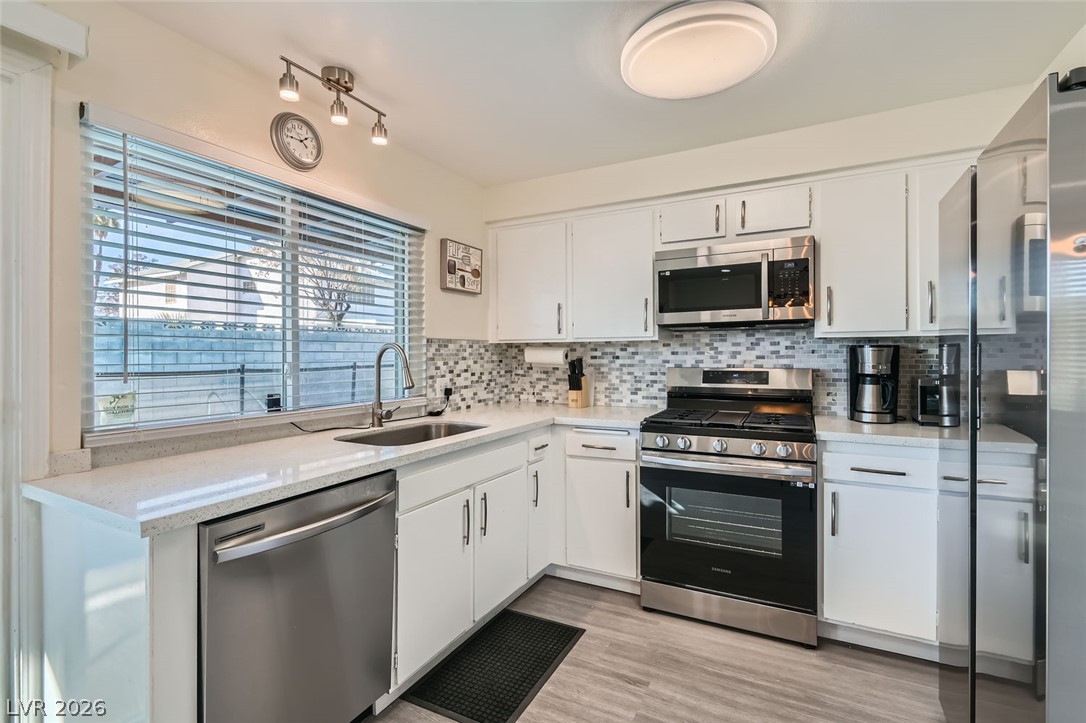 3665 Bronco Road Las Vegas, NV 89103 - Photo 10 of 28 Culinary delights await in this bright kitchen with modern stainless steel appliances and ample counter space.
