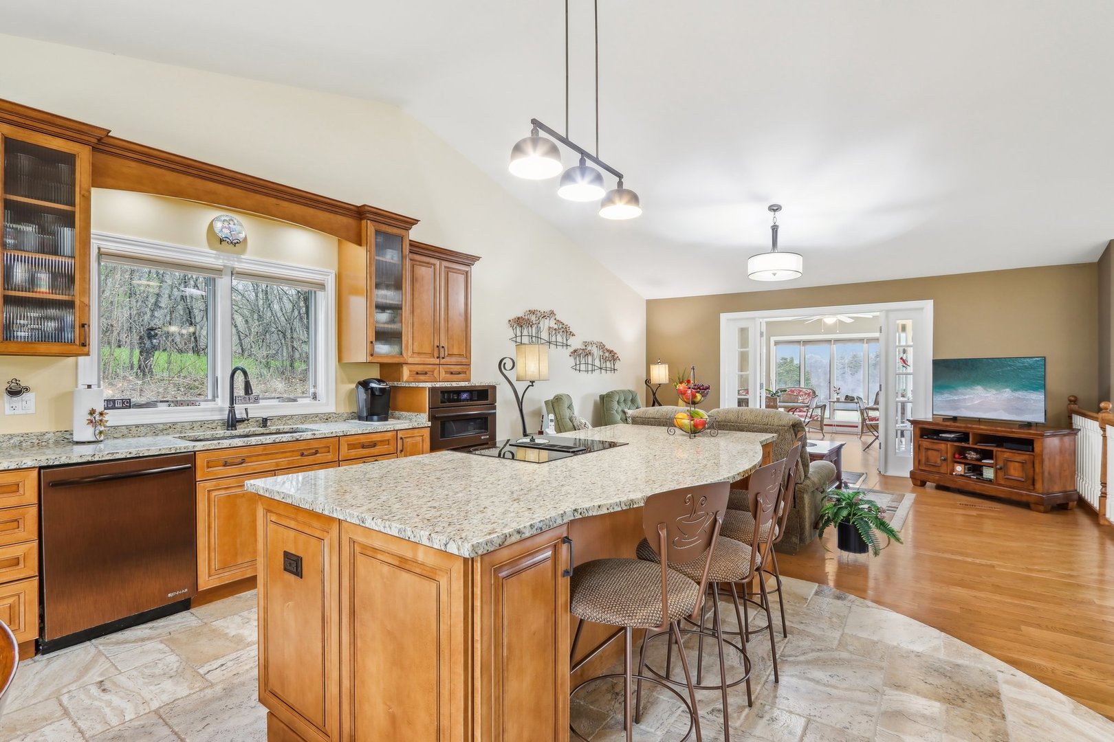 34550 Stanley Road Ingleside, IL 60041 - Photo 8 of 45 a large kitchen with granite countertop a stove a sink a dining table and chairs