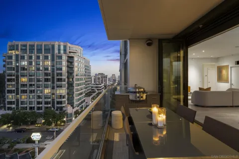 a bedroom with a large bed and a balcony view