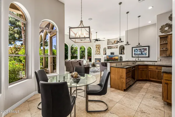 a front view of a house with outdoor seating and flowers