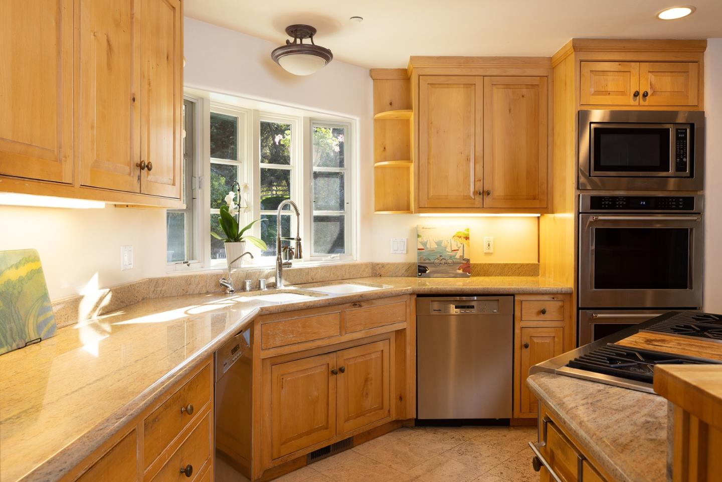 8680 River Meadows Road Carmel, CA 93923 - Photo 14 of 38 a kitchen with granite countertop a sink and a stove