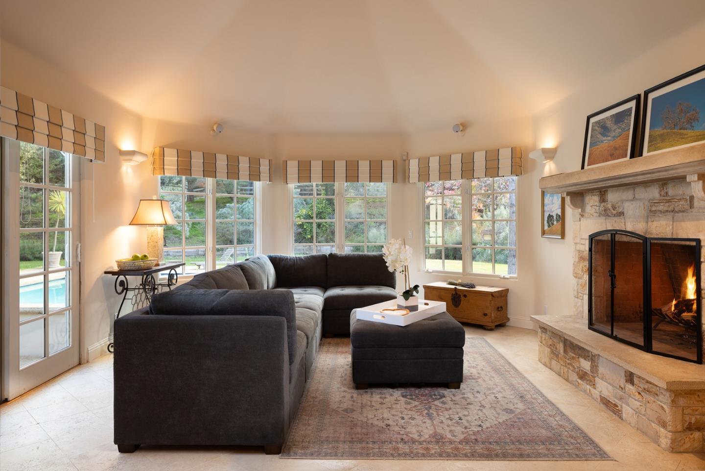8680 River Meadows Road Carmel, CA 93923 - Photo 17 of 38 a living room with furniture large window and a fireplace