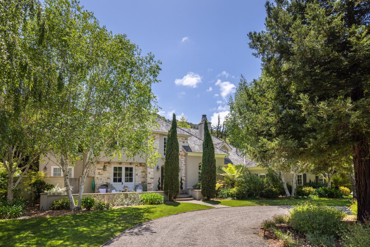 8680 River Meadows Road Carmel, CA 93923 - Photo 2 of 38 a front view of a house with garden and trees
