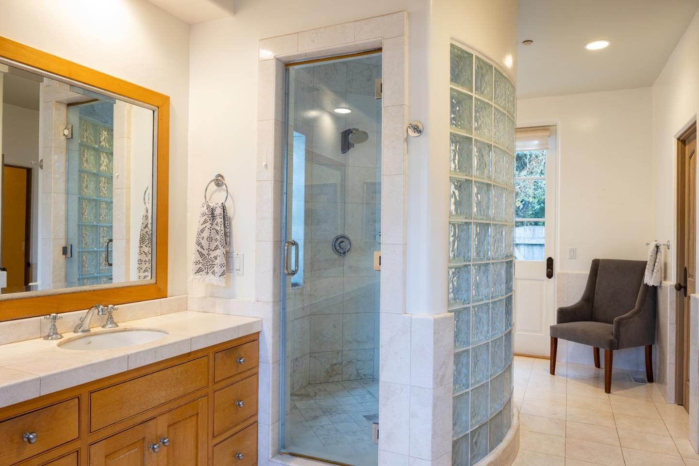 8680 River Meadows Road Carmel, CA 93923 - Photo 21 of 38 a bathroom with a shower sink and mirror