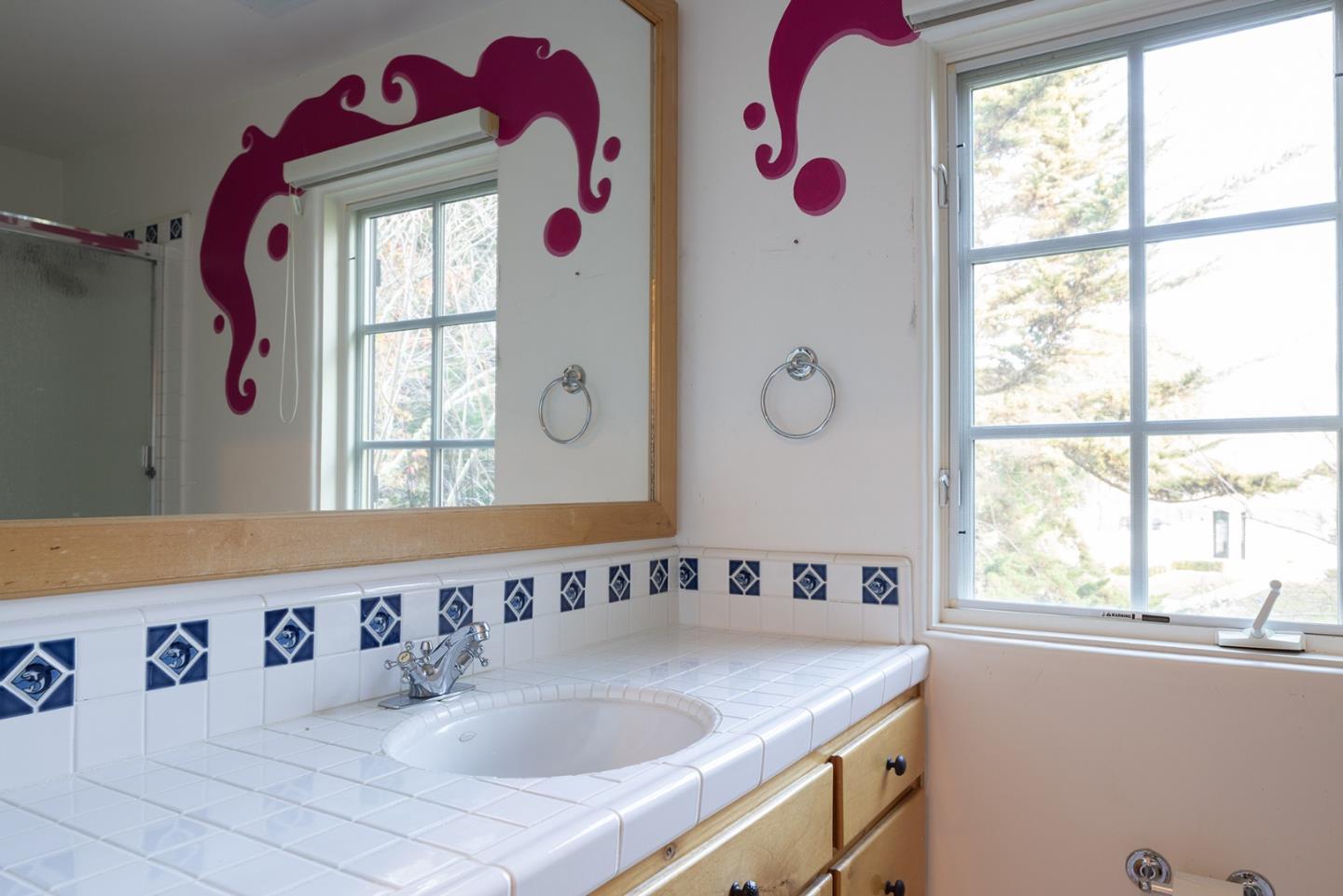 8680 River Meadows Road Carmel, CA 93923 - Photo 26 of 38 a bathroom with a granite countertop sink and a window