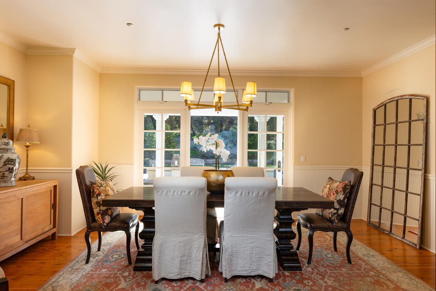 8680 River Meadows Road Carmel, CA 93923 - Photo 8 of 38 a dining room with furniture a chandelier and wooden floor
