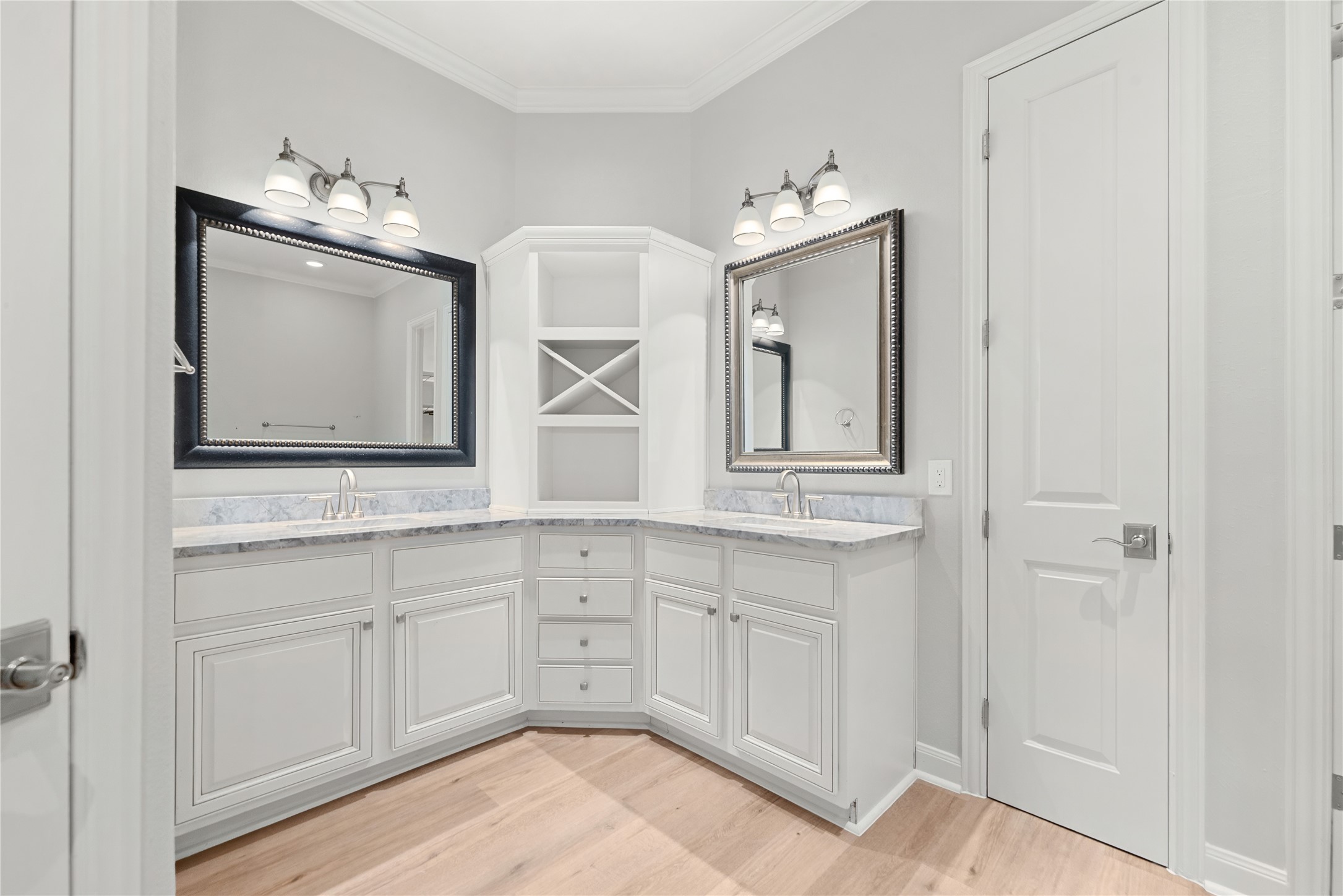 98 Herons Flight Place Spring, TX 77389 - Photo 15 of 29 Primary bath boasts dual vanities, marble countertops, and a unique corner design with built-in cabinetry for extra storage.