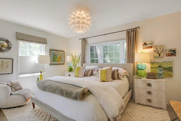 a bedroom with a bed and a chandelier