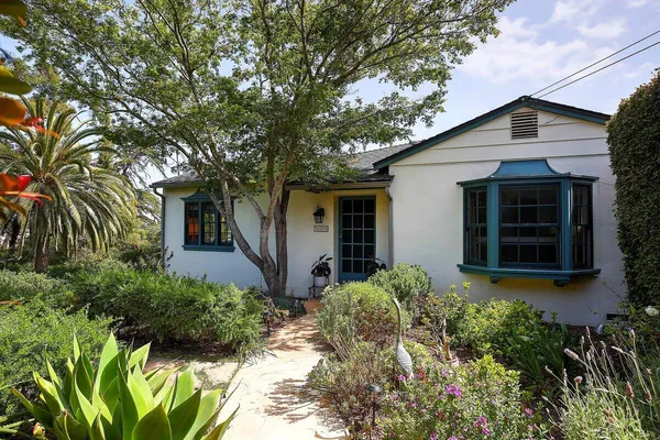 a front view of a house with garden