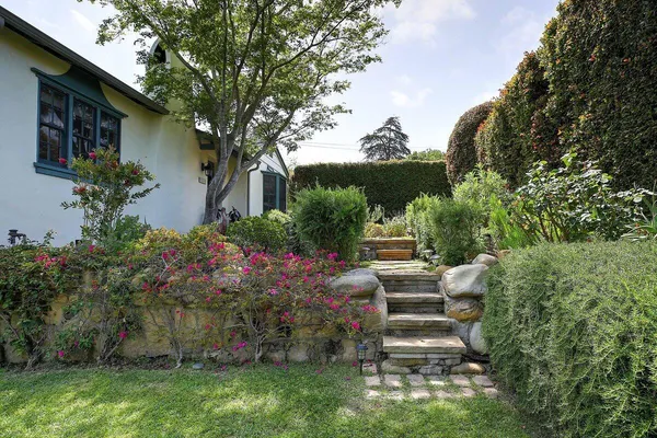 a view of a house with a yard and a garden