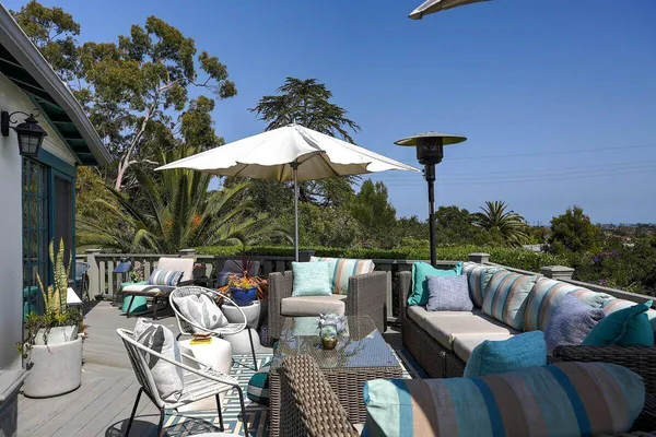 a balcony with outdoor seating and plants