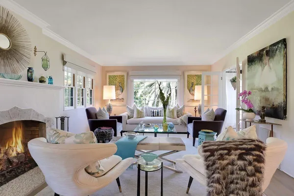 a living room with furniture fireplace and a large window