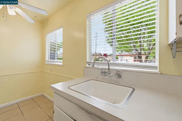 a bathroom with a sink a bathtub and next to a window