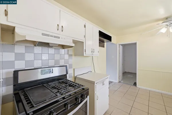 a stove top oven sitting inside of a kitchen