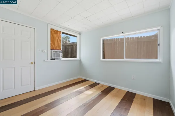 a view of a room with wooden floor and windows
