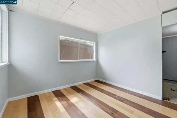 a view of a room with wooden floor and closet