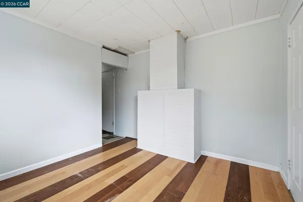 a bedroom with a bed and a wall painting