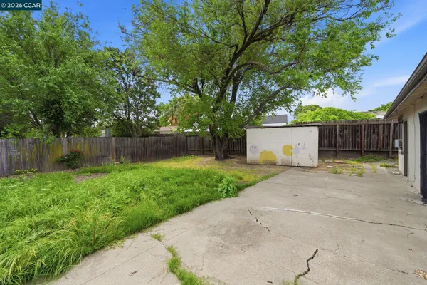 a front view of house with a yard and trees