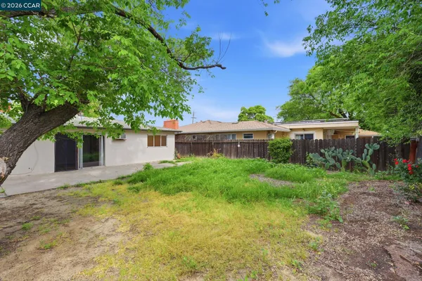 a front view of house with yard and trees