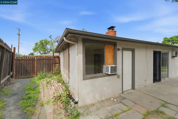 a view of a house with a small yard and plants