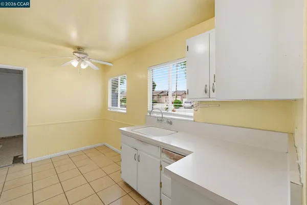 a view of a kitchen with a sink and cabinets