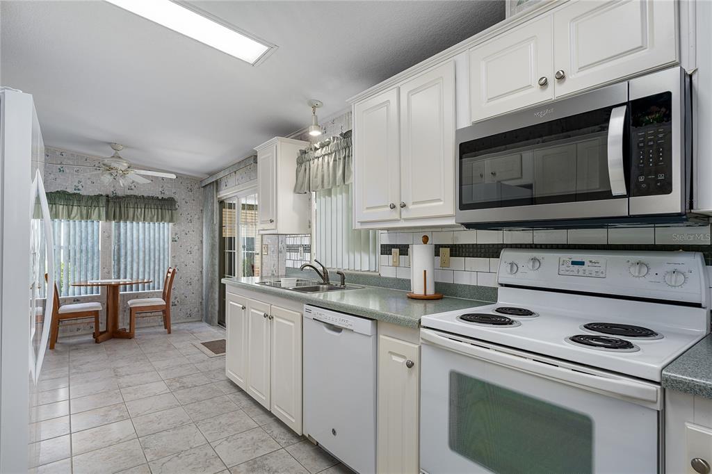 8012 Nancy Lane Ellenton, FL 34222 - Photo 11 of 28 a kitchen with appliances a sink and cabinets