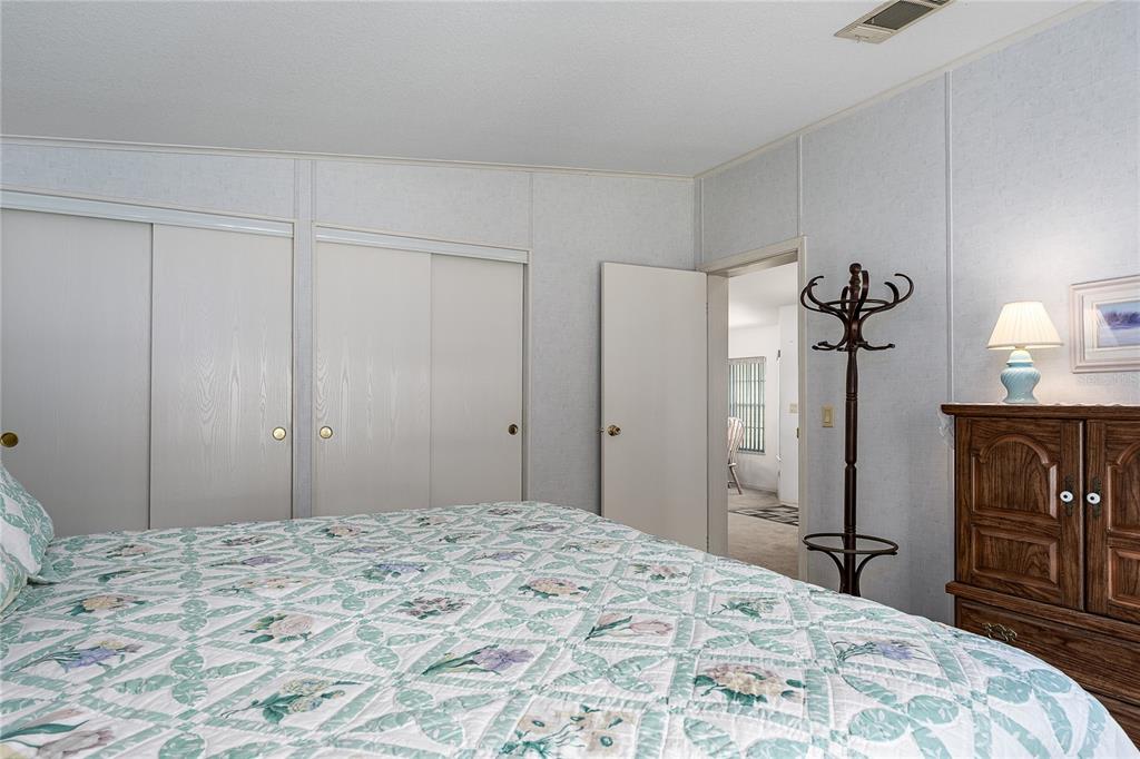 8012 Nancy Lane Ellenton, FL 34222 - Photo 19 of 28 a bedroom with a bed and a dresser