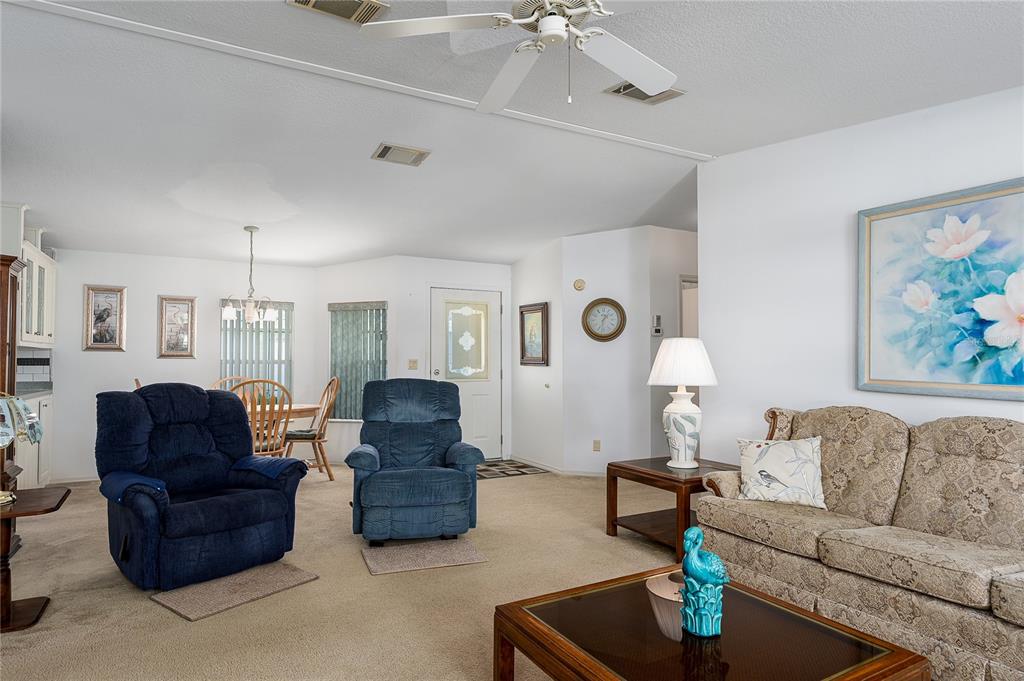 8012 Nancy Lane Ellenton, FL 34222 - Photo 6 of 28 a living room with furniture and a chandelier