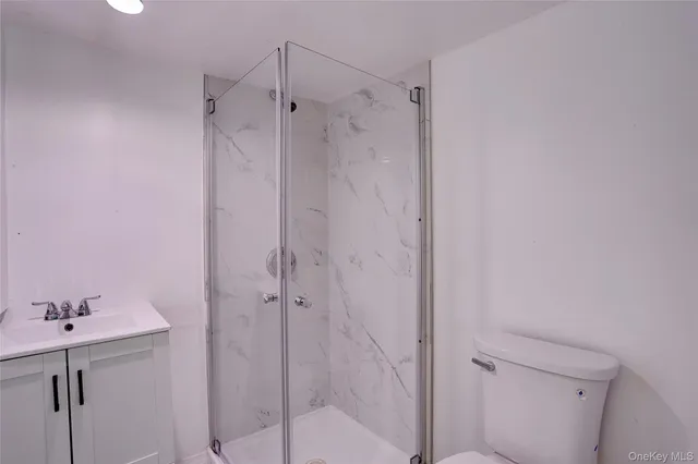 a bathroom with a shower and sink