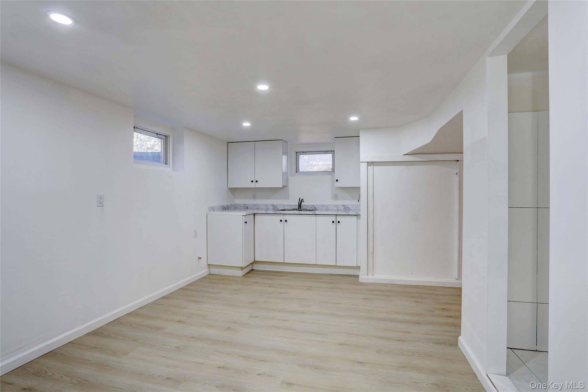 160 Pascack Road Chestnut Ridge, NY 10965 - Photo 18 of 25 a view of a kitchen with white cabinets and wooden floor