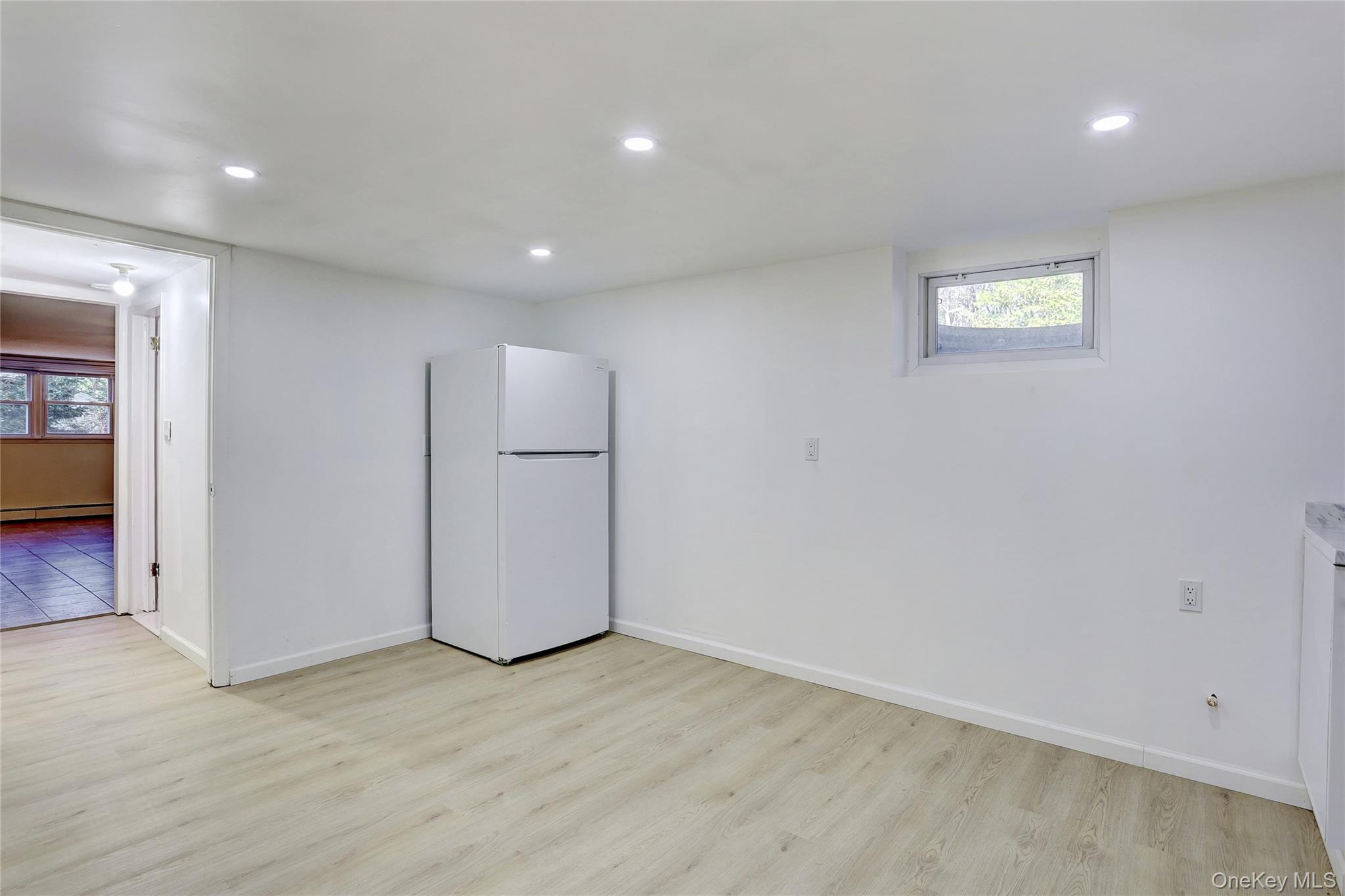 160 Pascack Road Chestnut Ridge, NY 10965 - Photo 19 of 25 an empty room with a window and a refrigerator