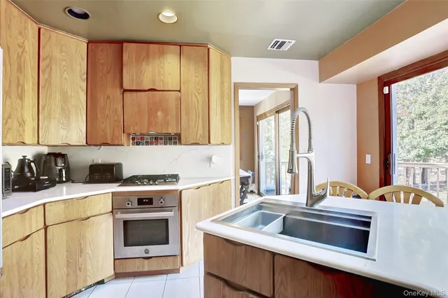 a kitchen with a stove a sink and a refrigerator