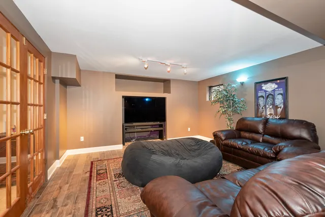 a bedroom with furniture and a flat screen tv