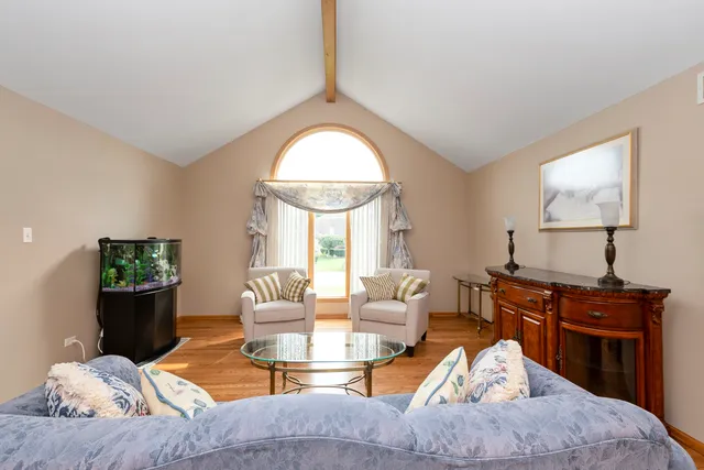 a living room with furniture a fireplace and a potted plant