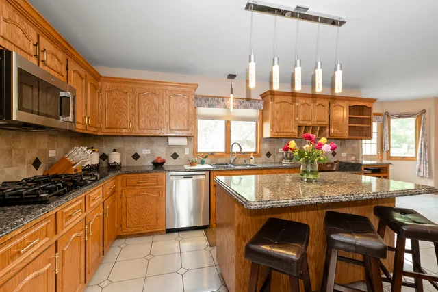 a kitchen with granite countertop a sink and cabinets