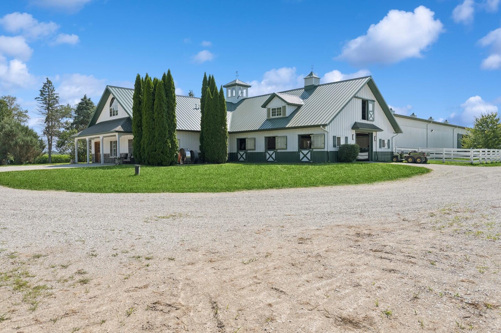 W1800 County Road B Bloomfield, WI 53128 - Photo 1 of 81 Impressive equestrian center with metal roof, multiple stall access points, and circular drive for convenient trailer movement.