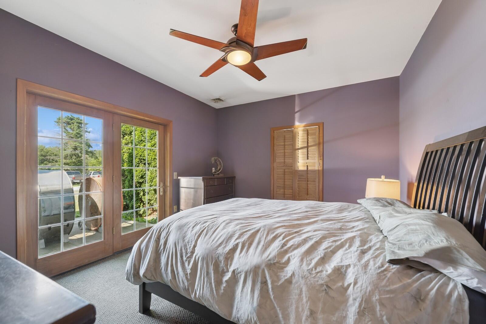W1800 County Road B Bloomfield, WI 53128 - Photo 17 of 81 Comfortable bedroom with ceiling fan, neutral finishes, and French doors providing natural light and direct outdoor access.