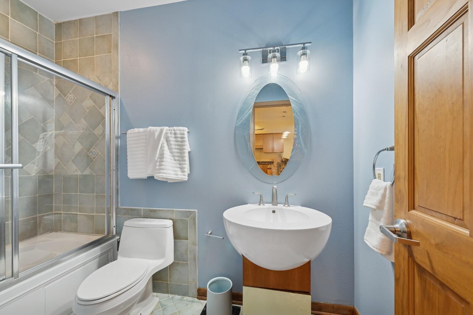W1800 County Road B Bloomfield, WI 53128 - Photo 18 of 81 Updated bathroom with tiled tub/shower surround, modern vanity, and contemporary fixtures in a clean, polished design.