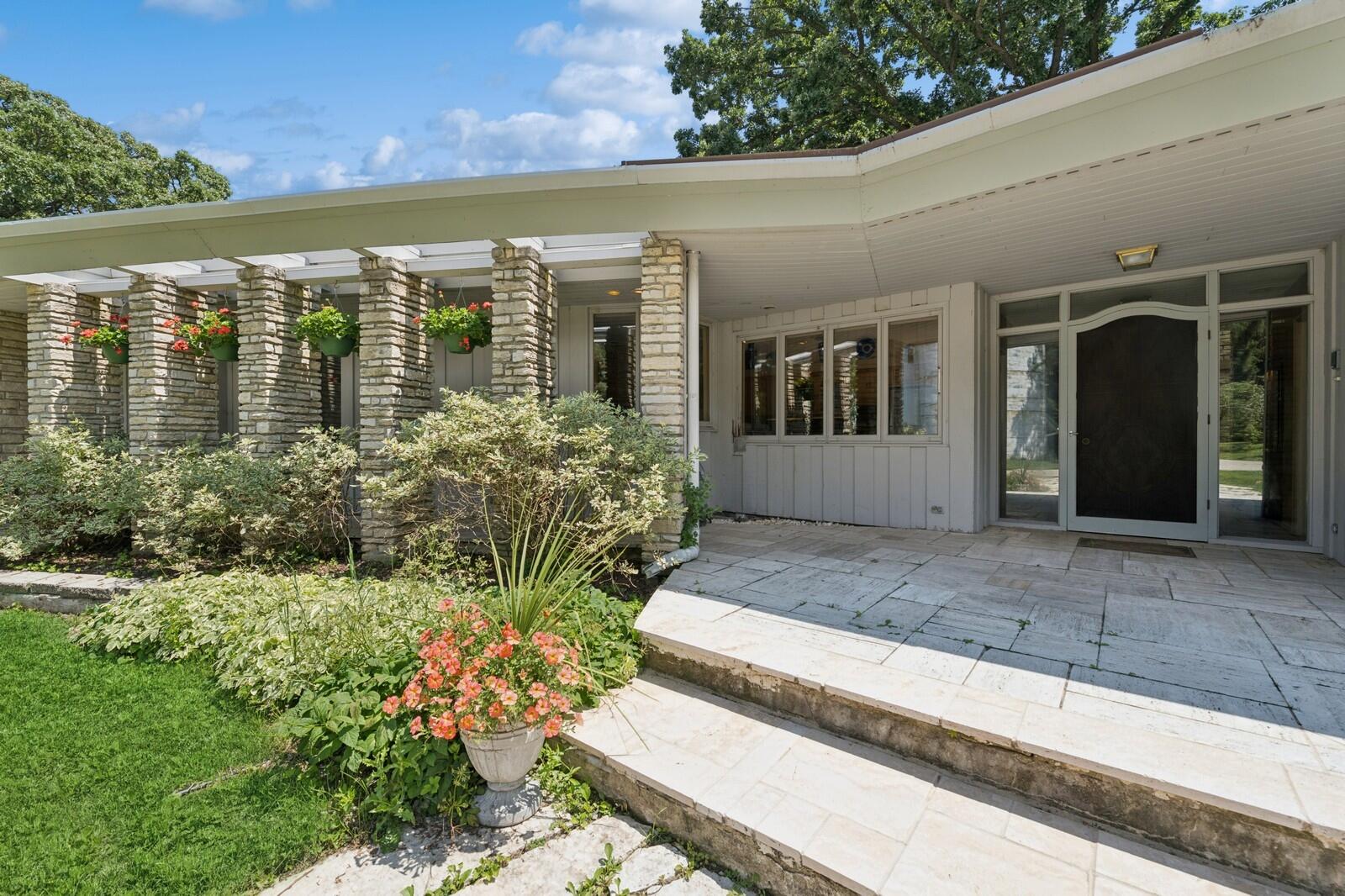 W1800 County Road B Bloomfield, WI 53128 - Photo 25 of 81 Inviting covered entry with stone columns, overhang protection, and a welcoming approach to the front door.