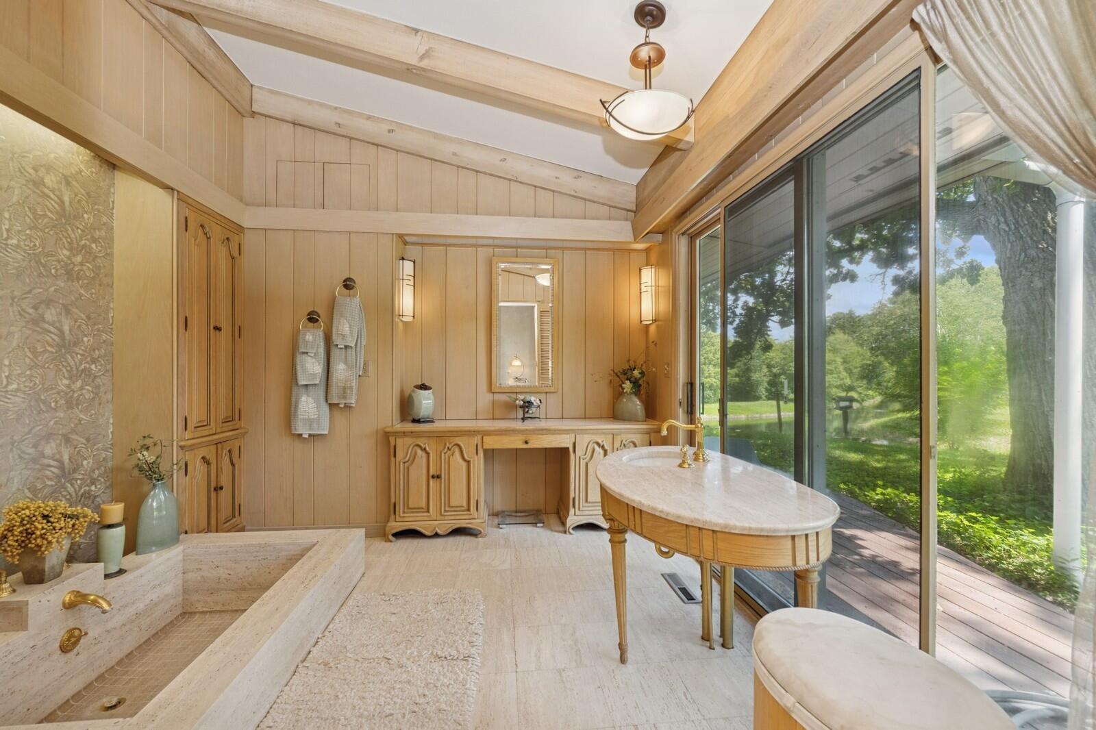 W1800 County Road B Bloomfield, WI 53128 - Photo 42 of 81 An expansive primary suite bathroom with soaking tub, custom cabinetry, and elegant finishes, designed for relaxation and everyday comfort.