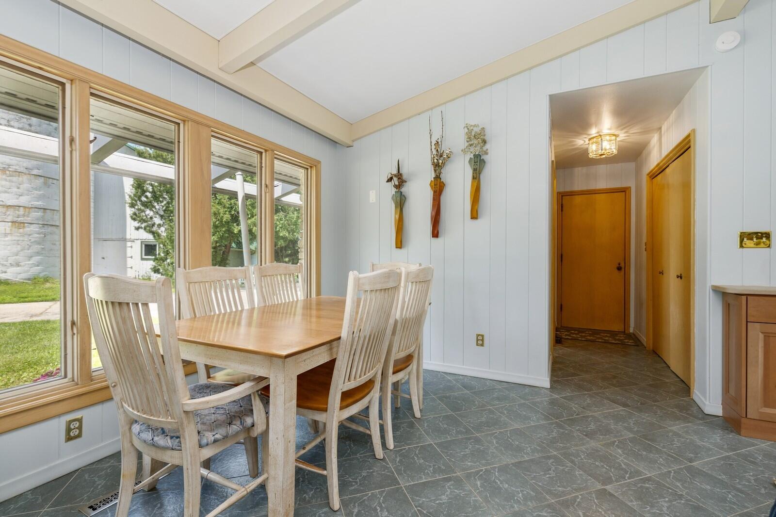 W1800 County Road B Bloomfield, WI 53128 - Photo 48 of 81 A casual dining nook with tile flooring and large windows, offering a bright space for everyday meals with views of the surrounding grounds.