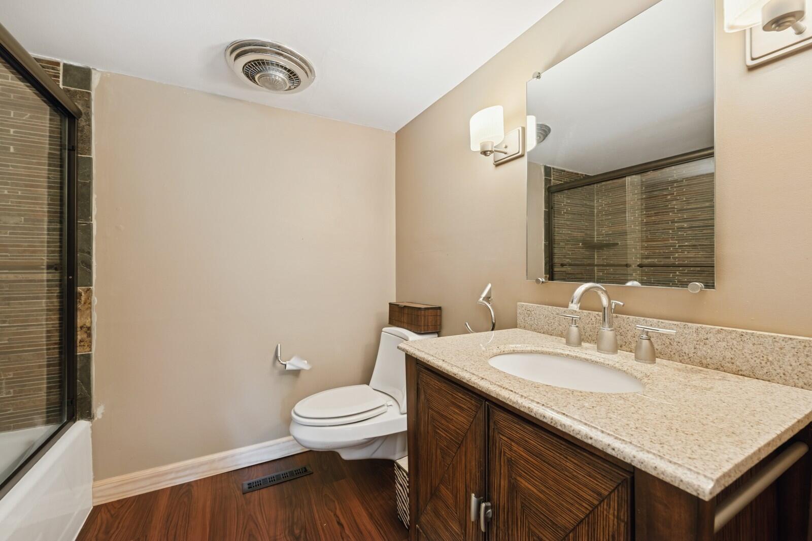 W1800 County Road B Bloomfield, WI 53128 - Photo 51 of 81 Bathroom with solid-surface countertop, modern fixtures, and a walk-in shower, offering a clean and functional design.