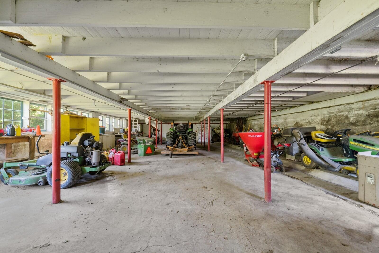 W1800 County Road B Bloomfield, WI 53128 - Photo 63 of 81 Large lower-level storage area with concrete flooring, support columns, and ample room for tractors, tools, and equipment.