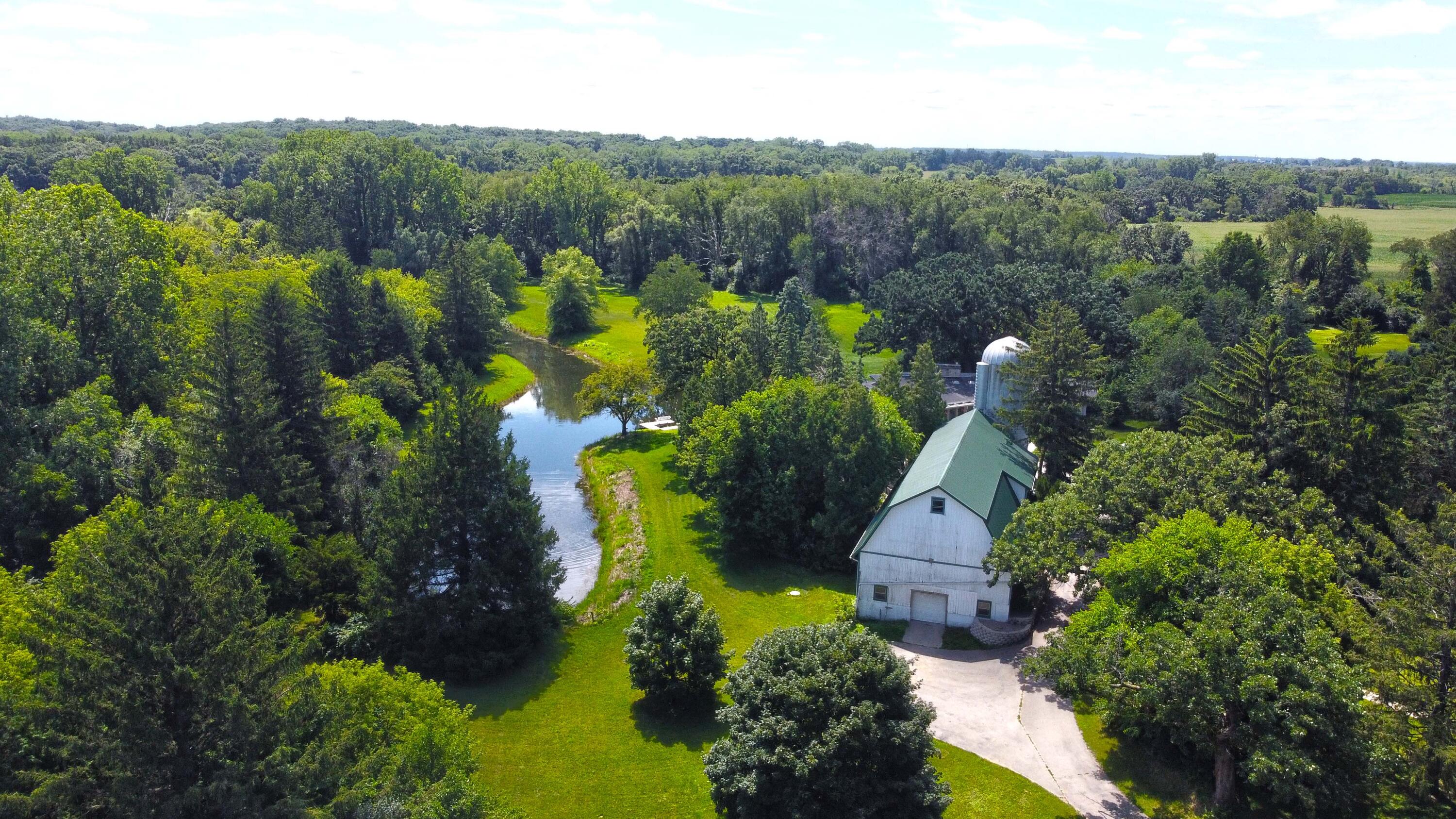 W1800 County Road B Bloomfield, WI 53128 - Photo 64 of 81 Concrete foundation and metal roof (installed July 2021) makes this 34’x94 (3196 sqft) wood barn great for storage of hay, but also great for gatherings and winter car storage with easy driveway access.